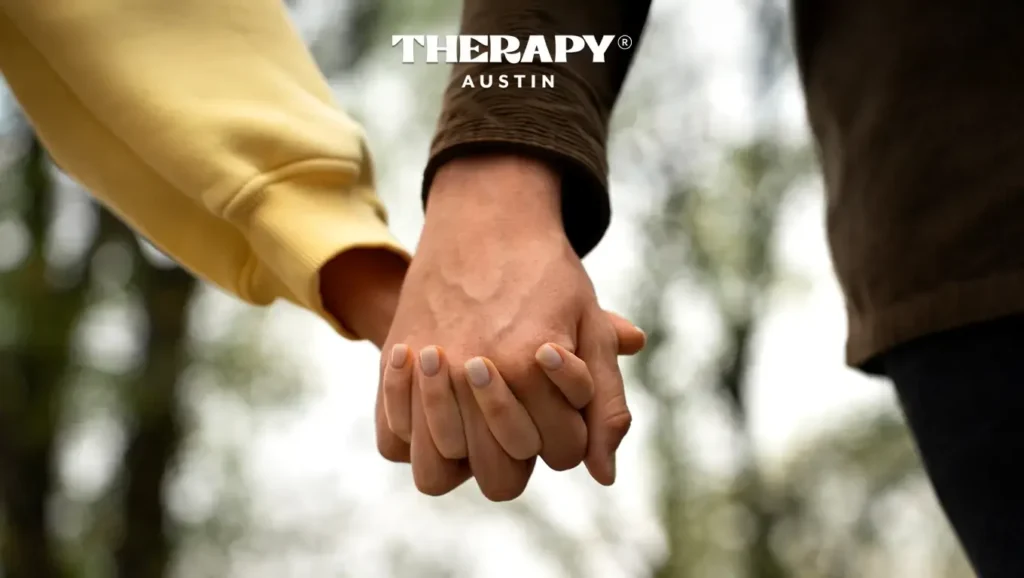 A couple holding hands highlighting the value of therapy in providing the right strategies for conflict resolution.